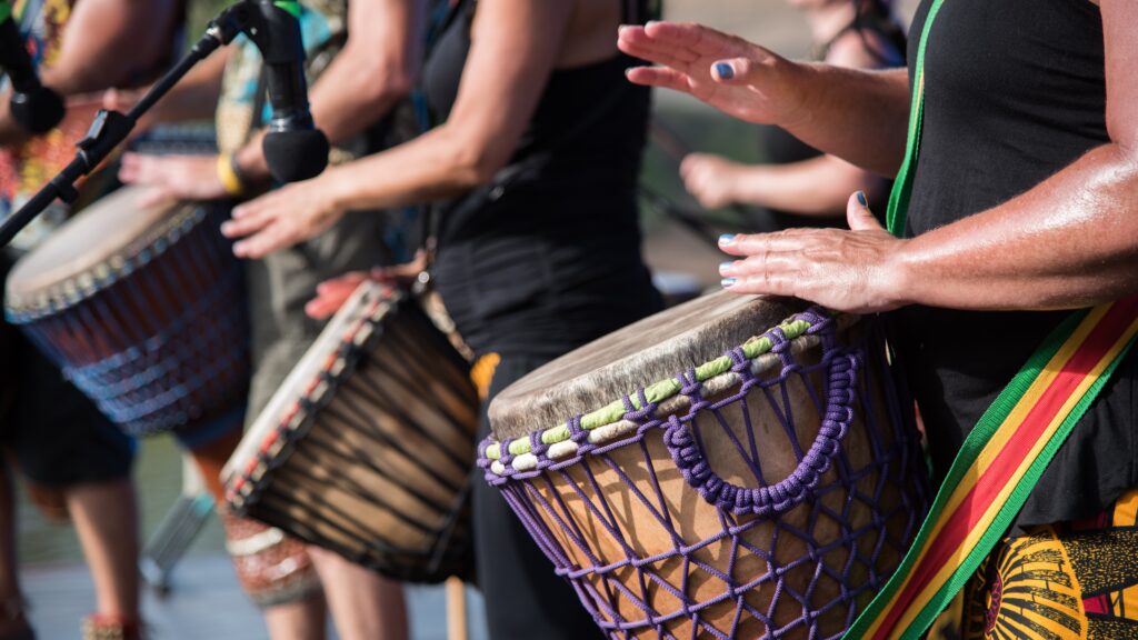 people drumming in a group