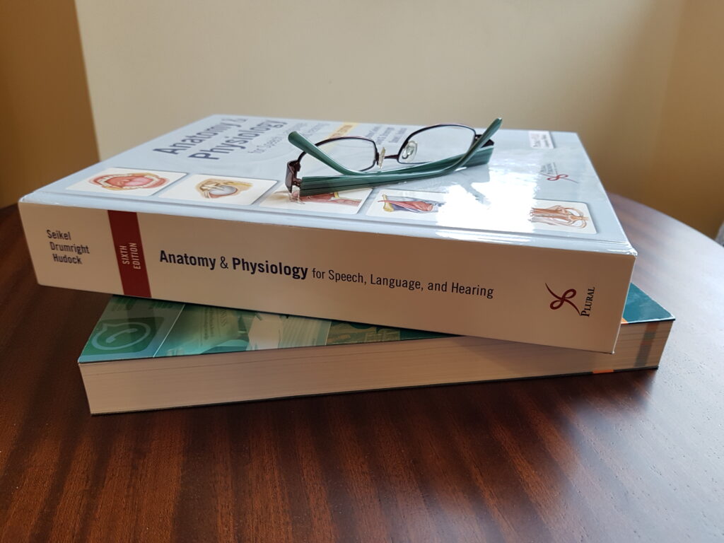 two big books and some reading glasses